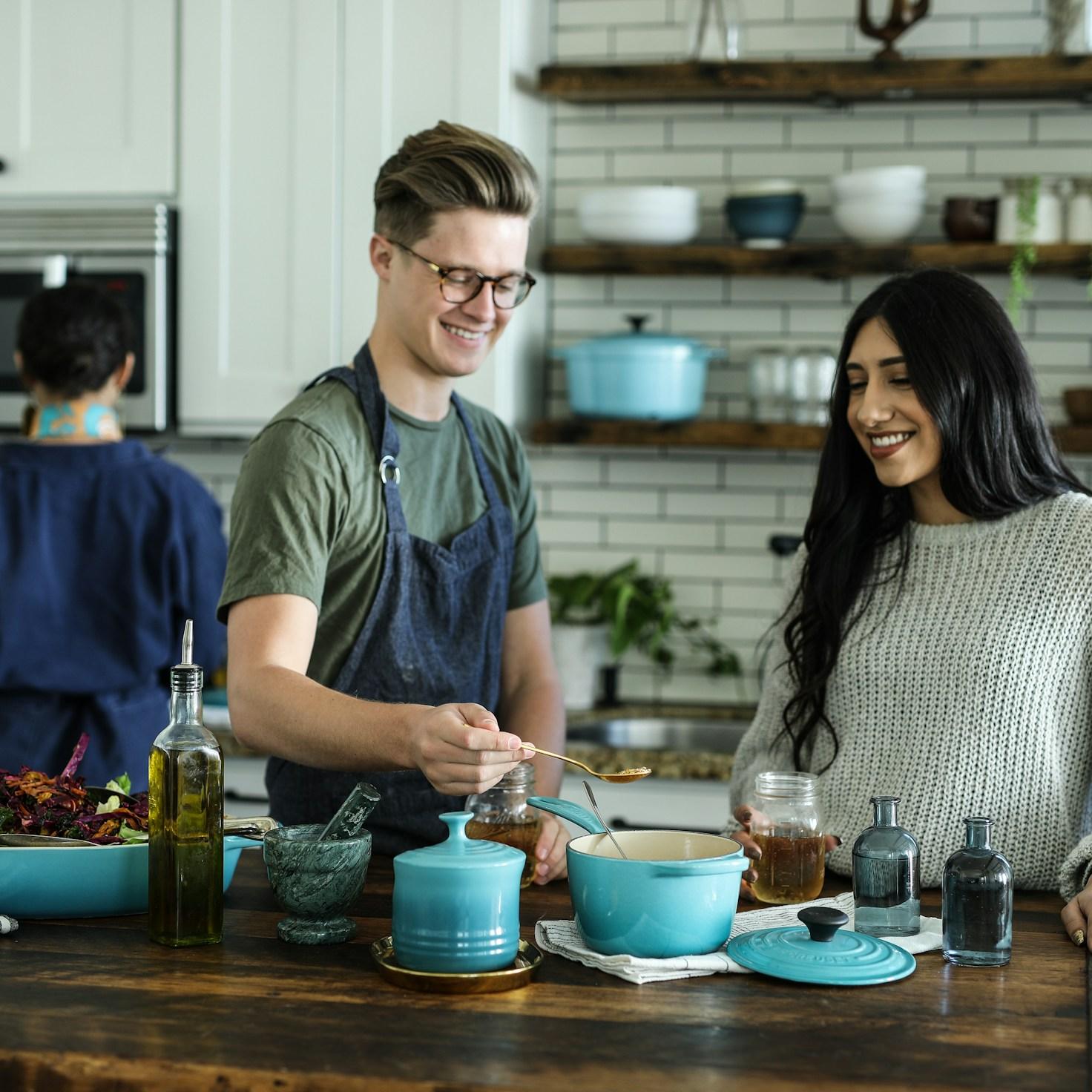Community members collaborating in a contemporary kitchen, exchanging recipes and techniques